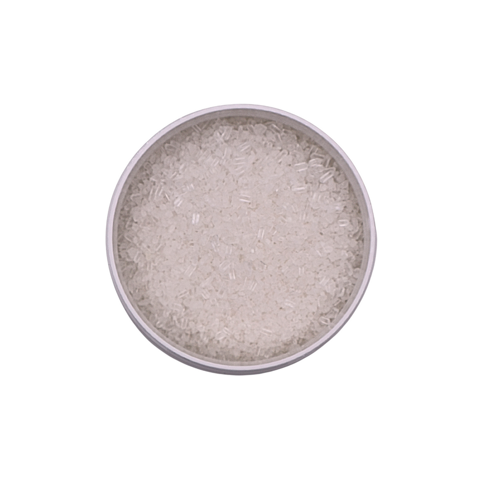 Silver-colored powder in a round container on a white background