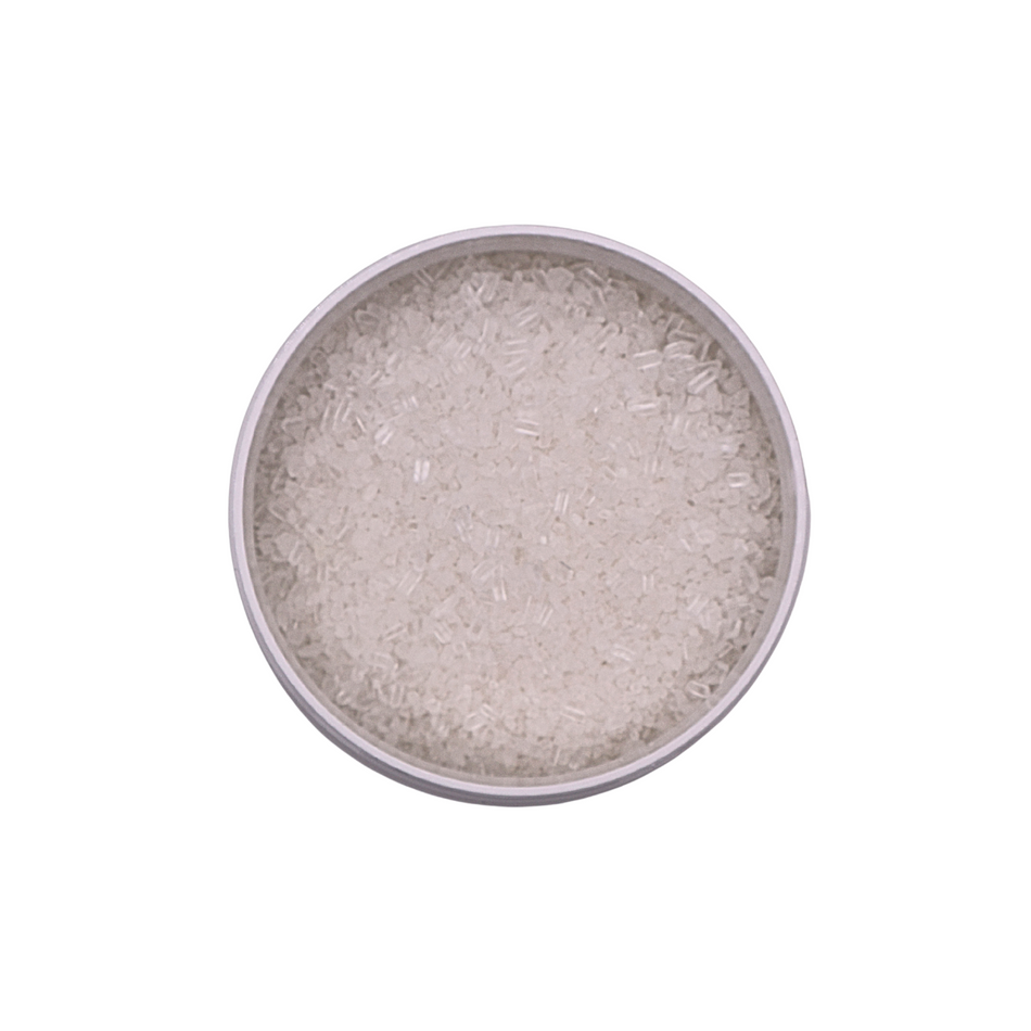 Silver-colored powder in a round container on a white background